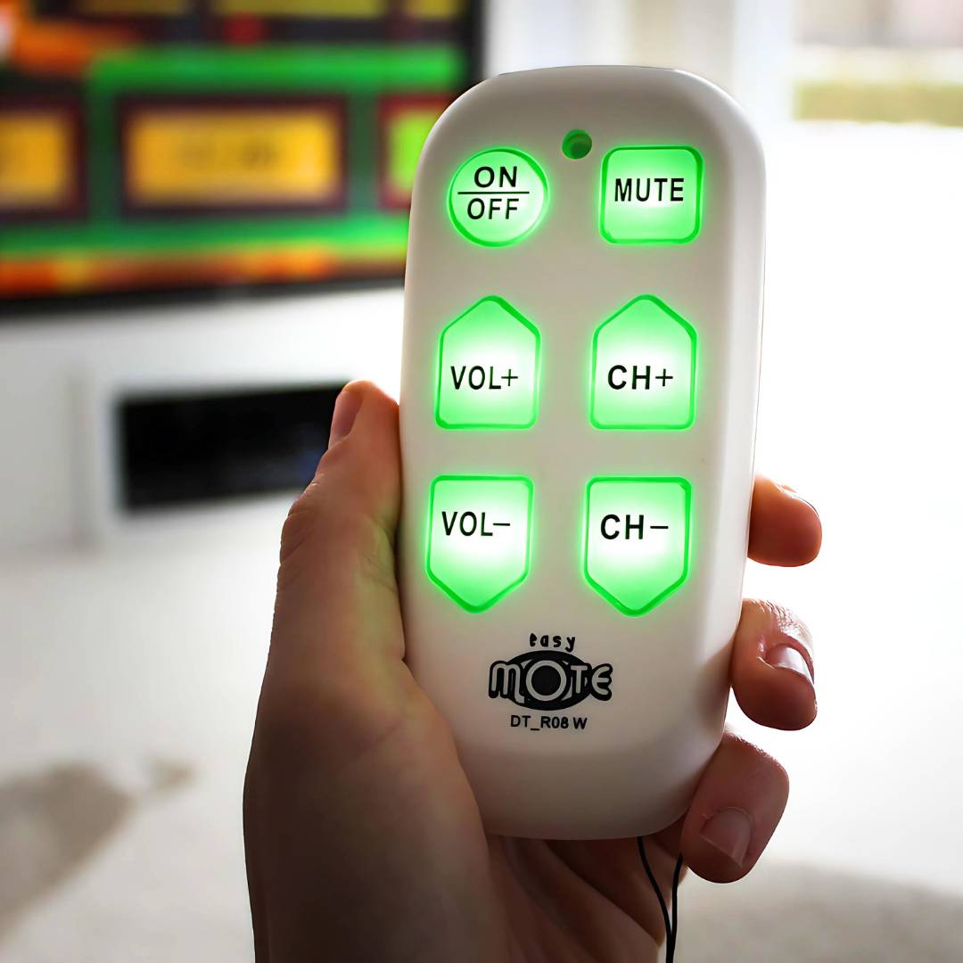 Big button TV remote in hand with backlit buttons