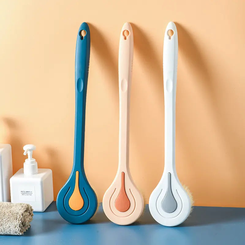 three long handled back scrubbers aligned in bathroom setting