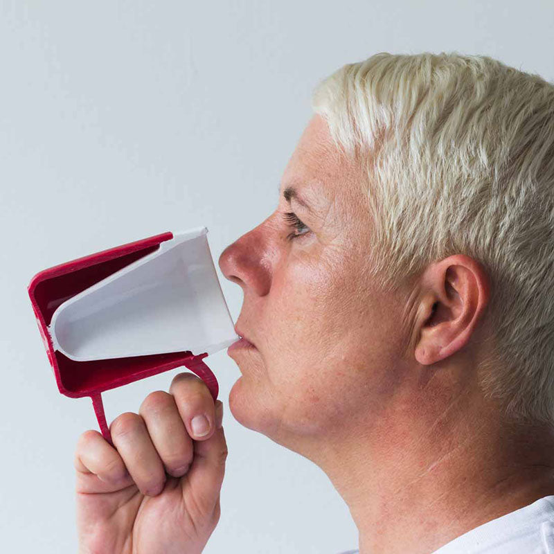person drinking from plastic mug beaker with internal cone cross section