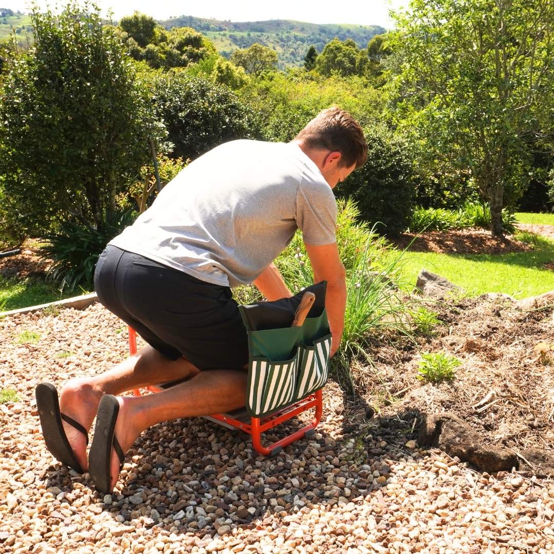 Person kneeling and weeding using the garden seat kneeler and seat