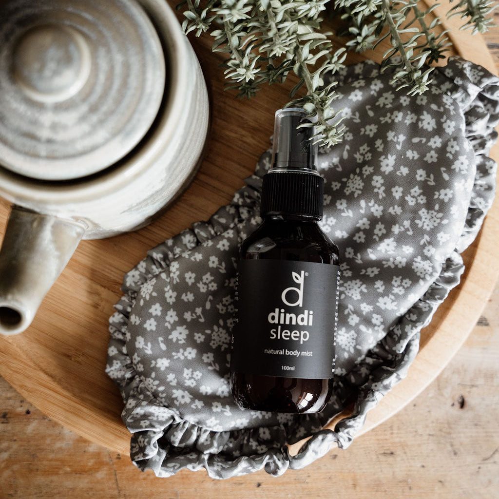 Dindi natural sleep body mist on wooden board with eye mask and tea pot