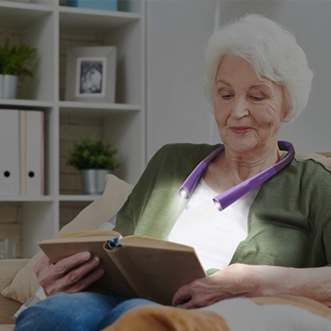 elderly person using neck light to read