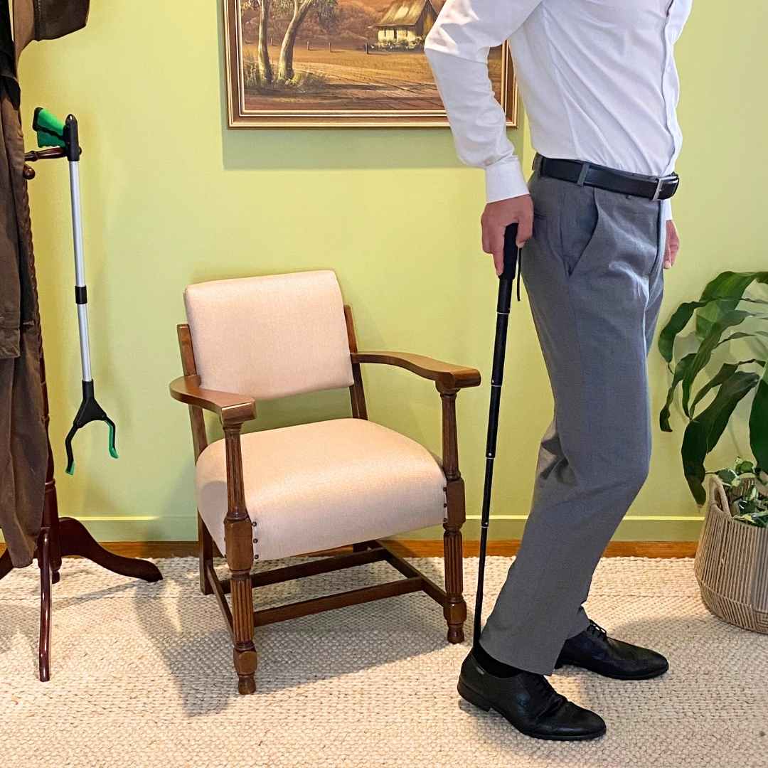 person using the extendable shoe horn at full length