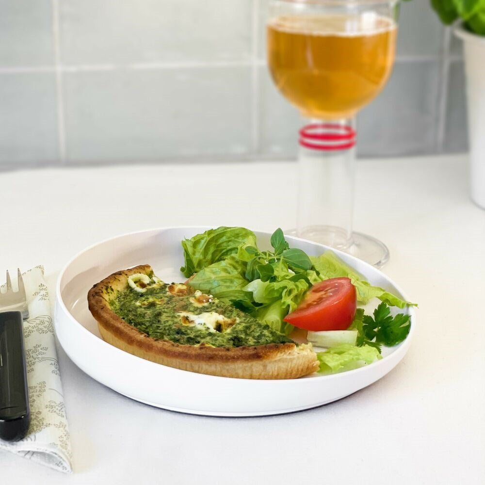 high edged plate with a meal and drink