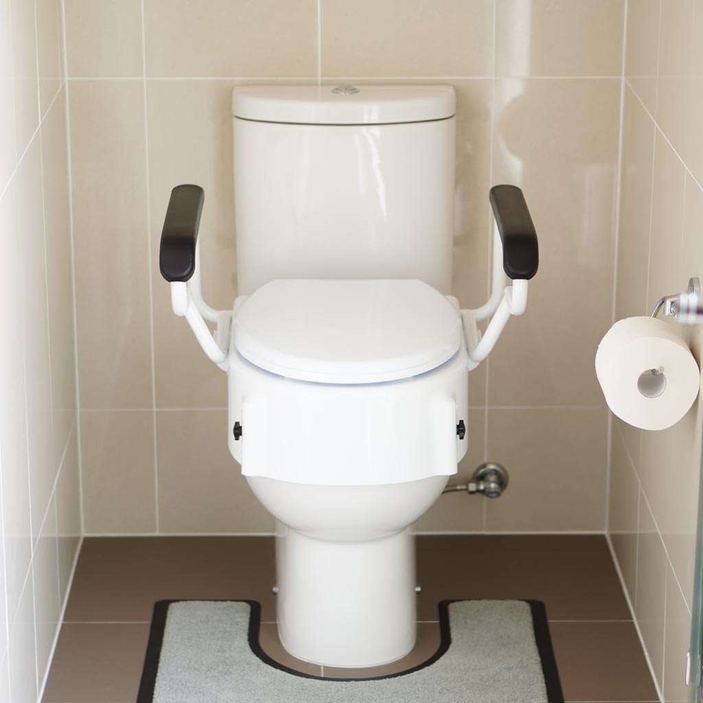 Adjustable toilet seat mounted on toilet, raised 100mm