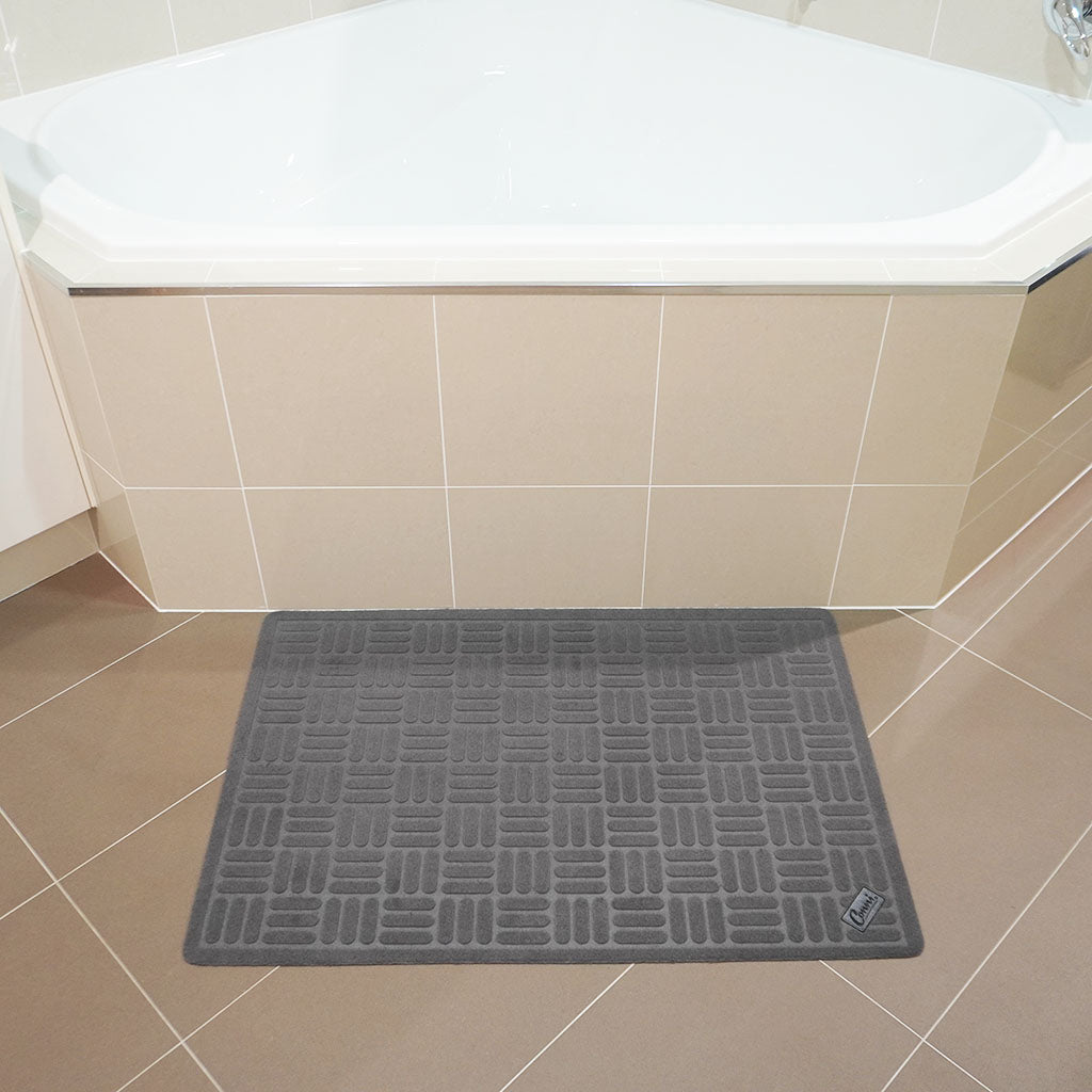 Conni charcoal stepstone mat in front of bathtub