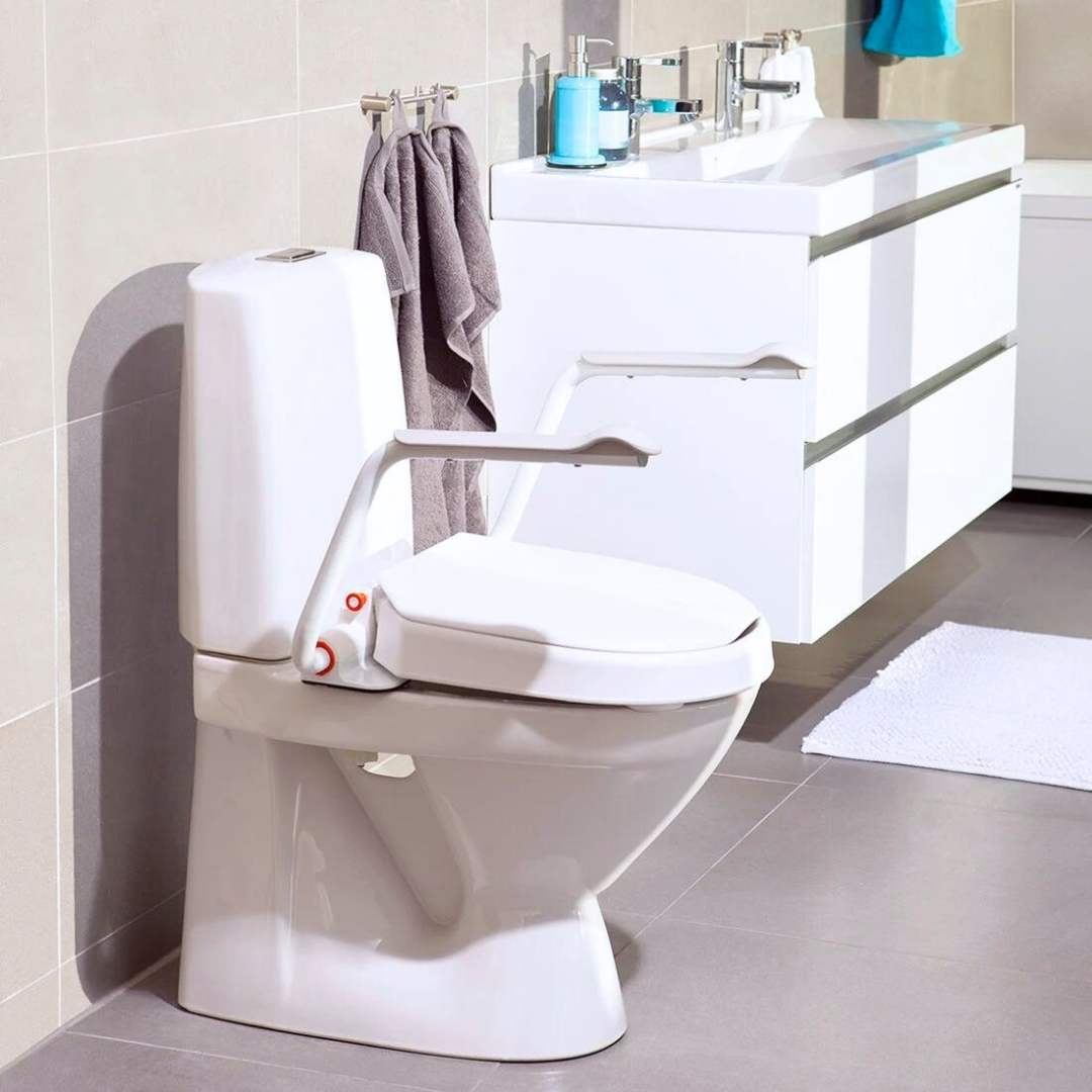 Etac Hi-Loo toilet seat raiser with armrests mounted on toilet in bathroom