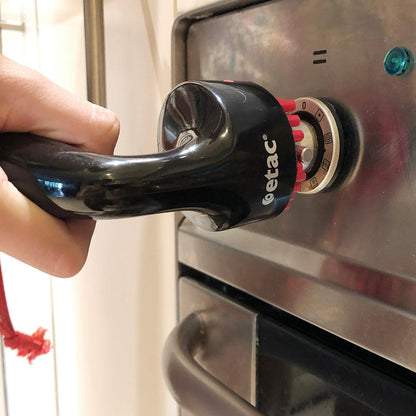 person using universal tap and handle turner to turn on oven