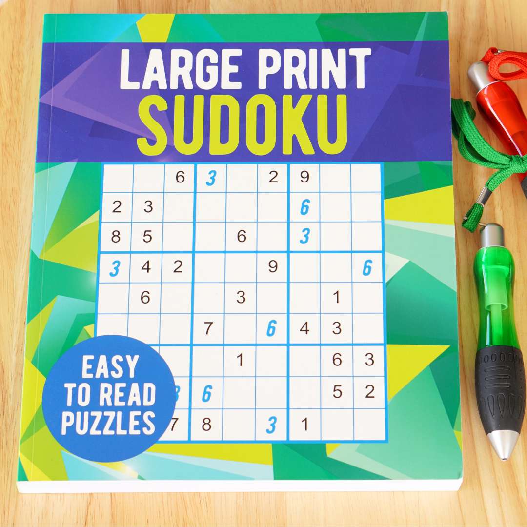 Cover of the large print Sudoku book with two pens next to it