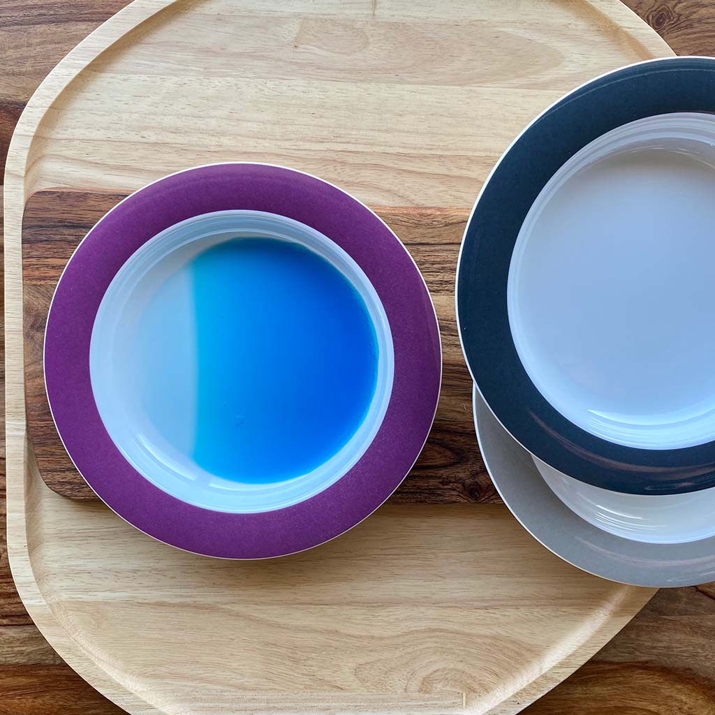sloped plates with blue liquid showing tilt on flat wooden boards