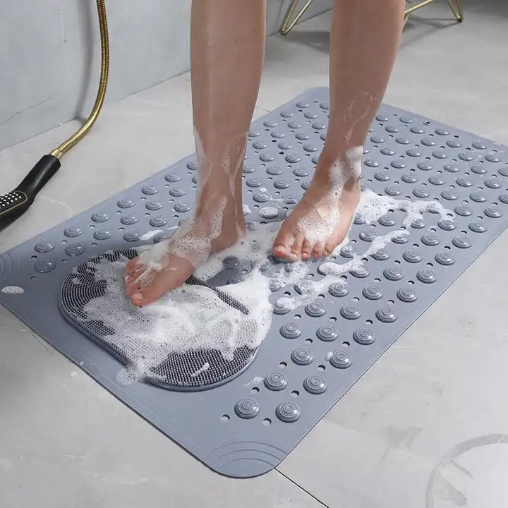 person standing on the bath mat and using the foot cleaning pad