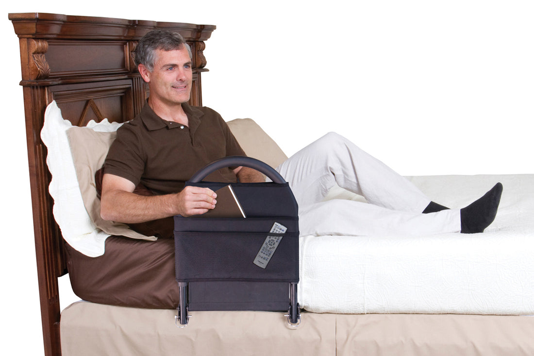 person sitting upright on bed reaching into pouch of mounted bed rail