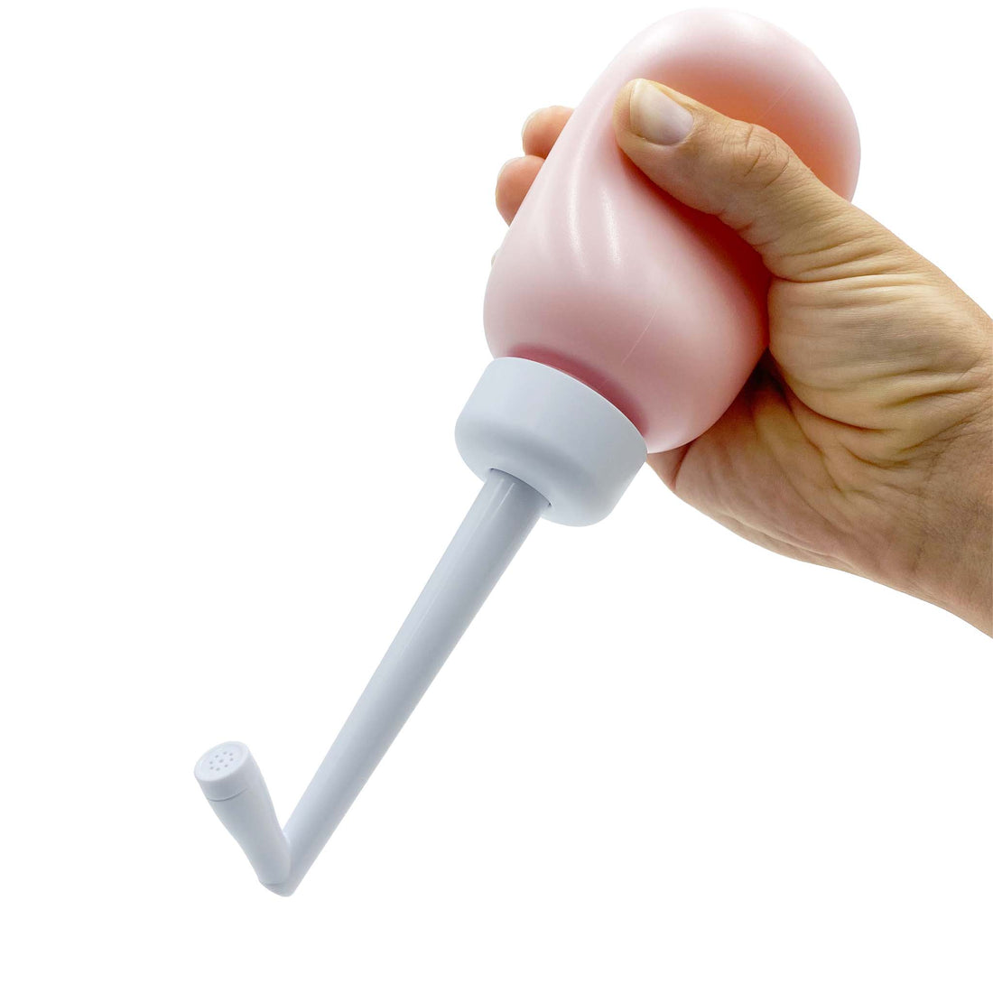 hand squeezing portable bidet in pink