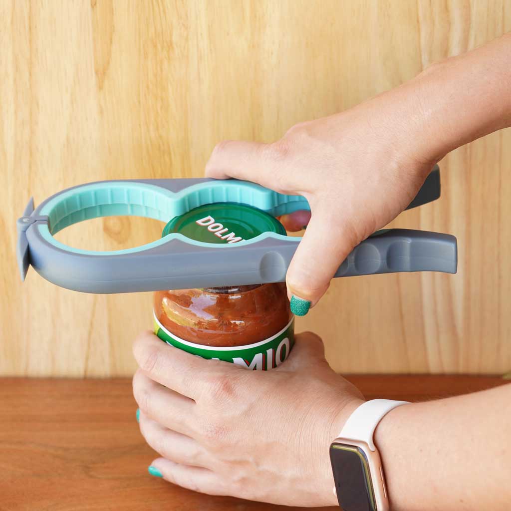 blue bottle, jar and can opener in use to open a tomato sauce jar