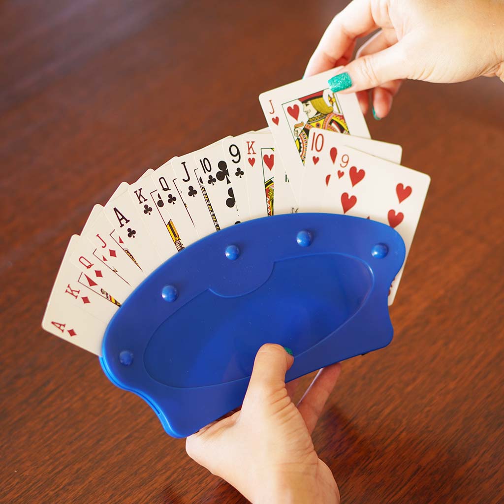 playing card holder being held in one hand whilst the other hand pulls one card out