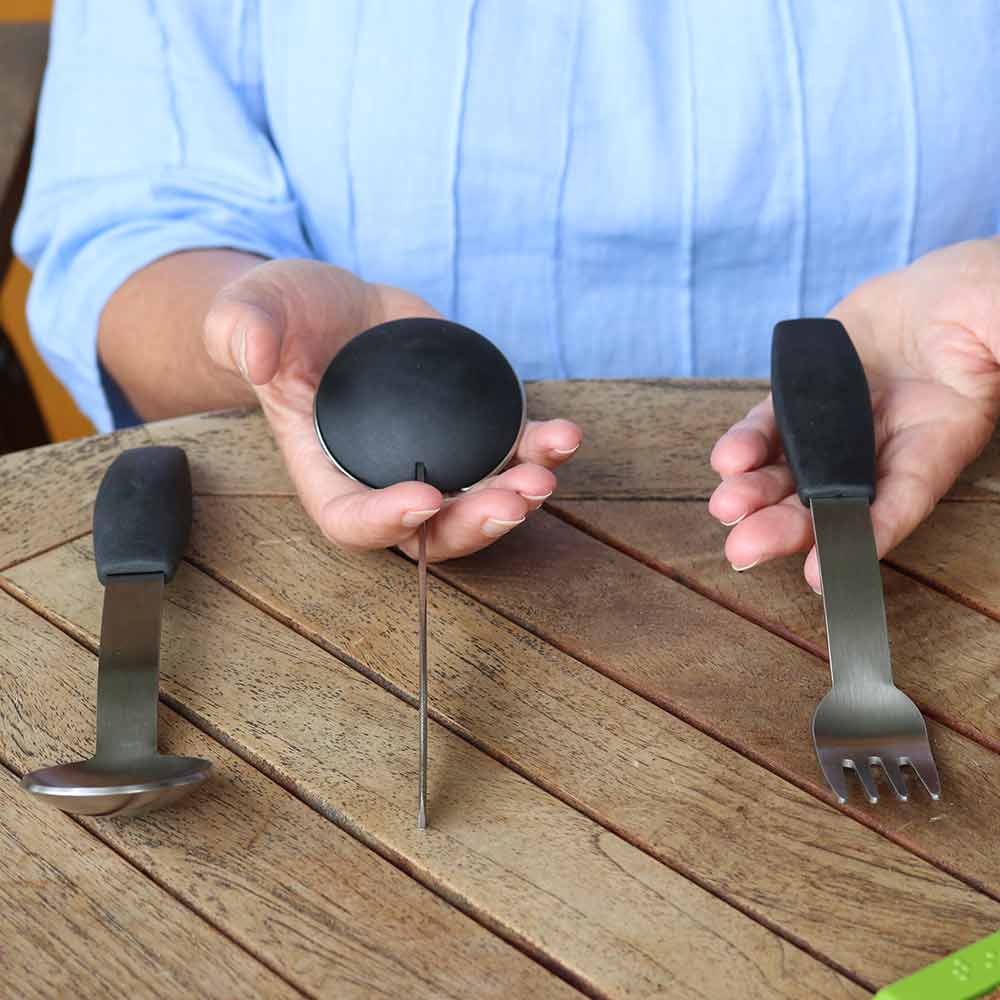 person holding arthritis cutlery set