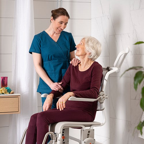 nurse assisting person in shower chair