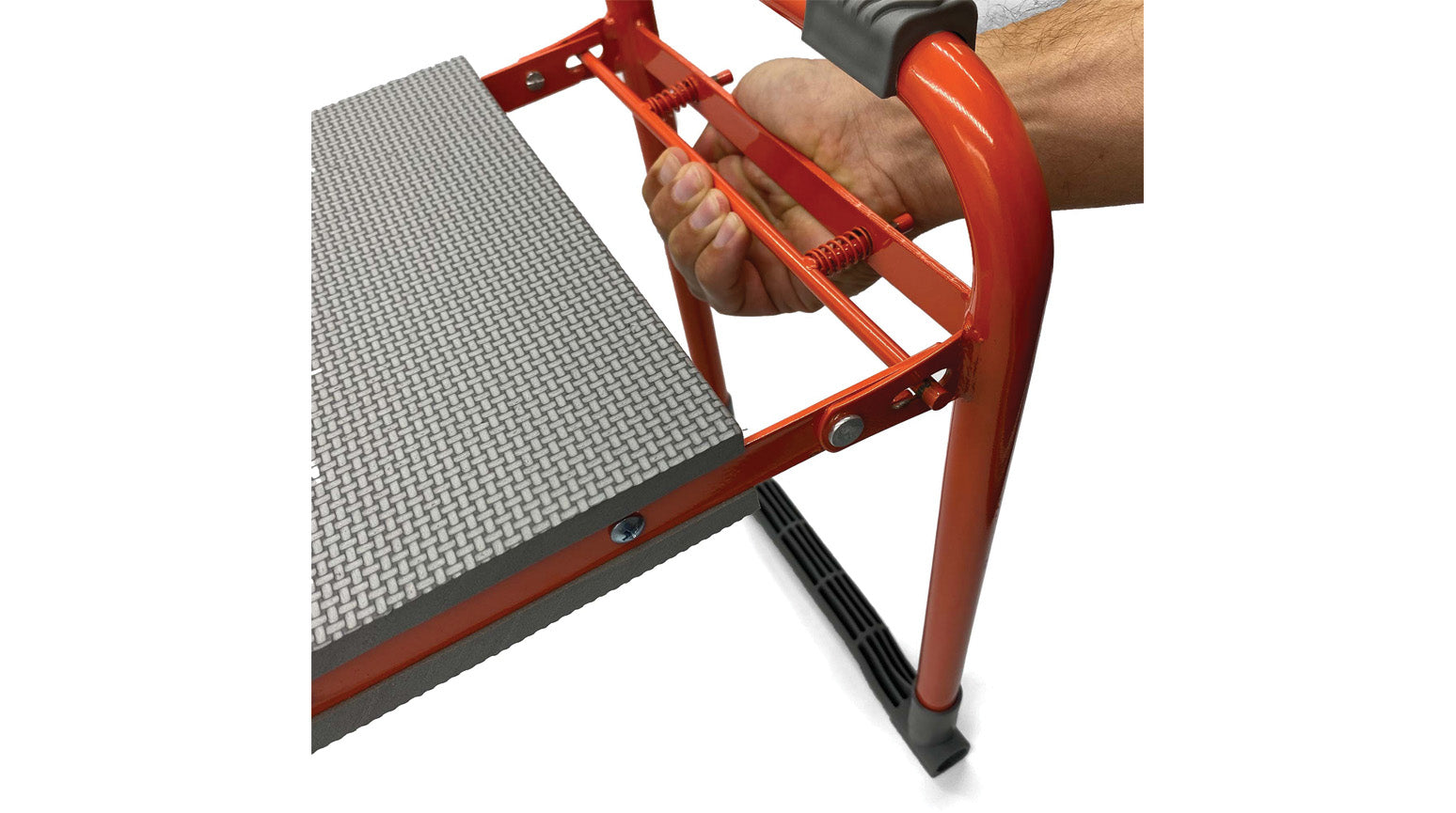 hand unlocking a garden seat and kneeler to fold it down