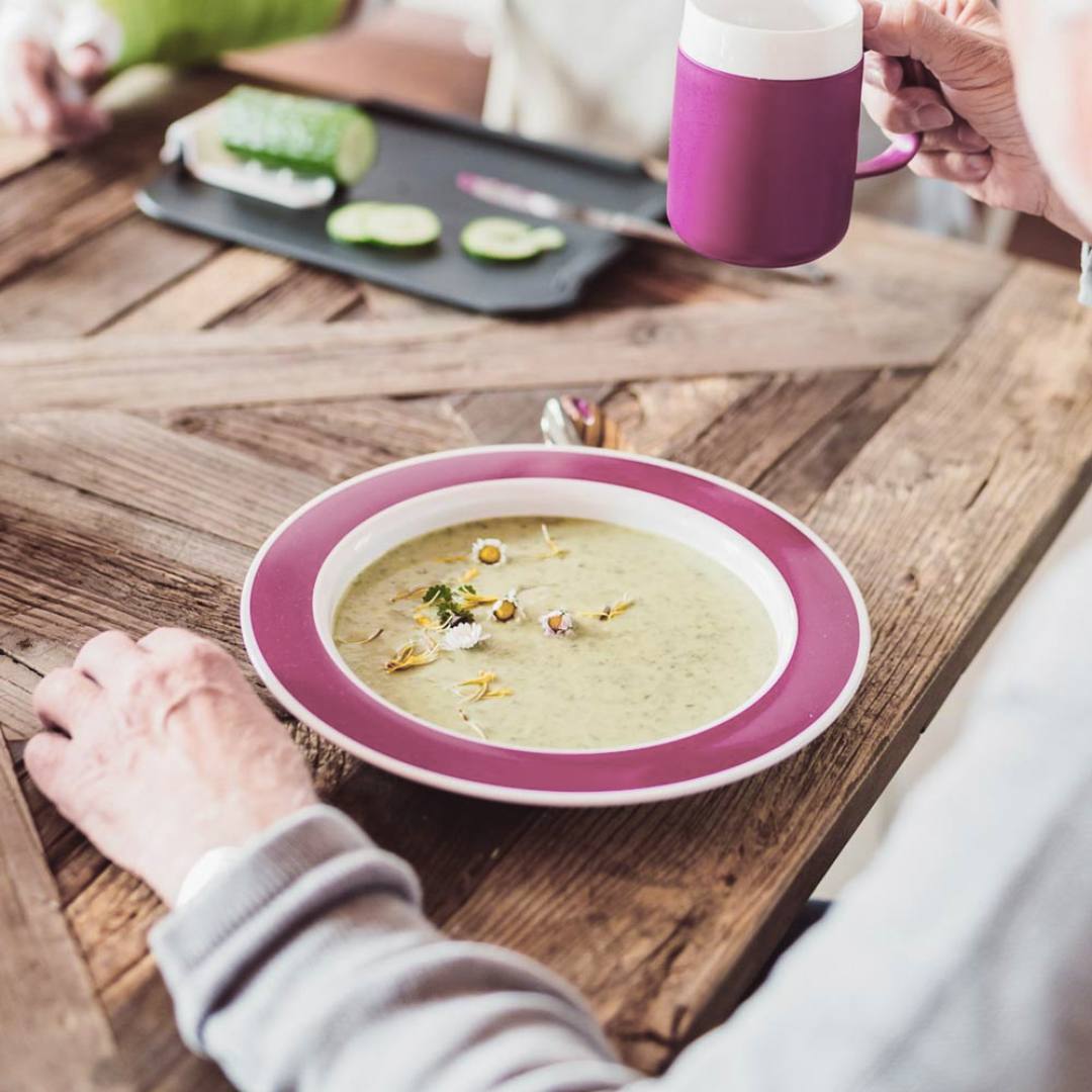 person eating and drinking using ORNAMIN tableware