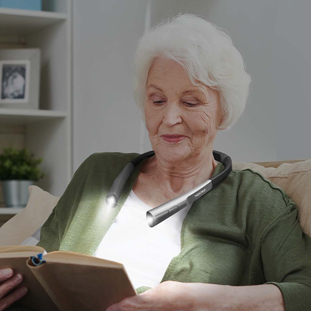 elderly person using neck light to read