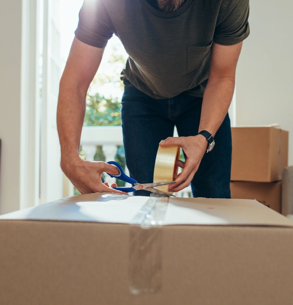 person packing a box