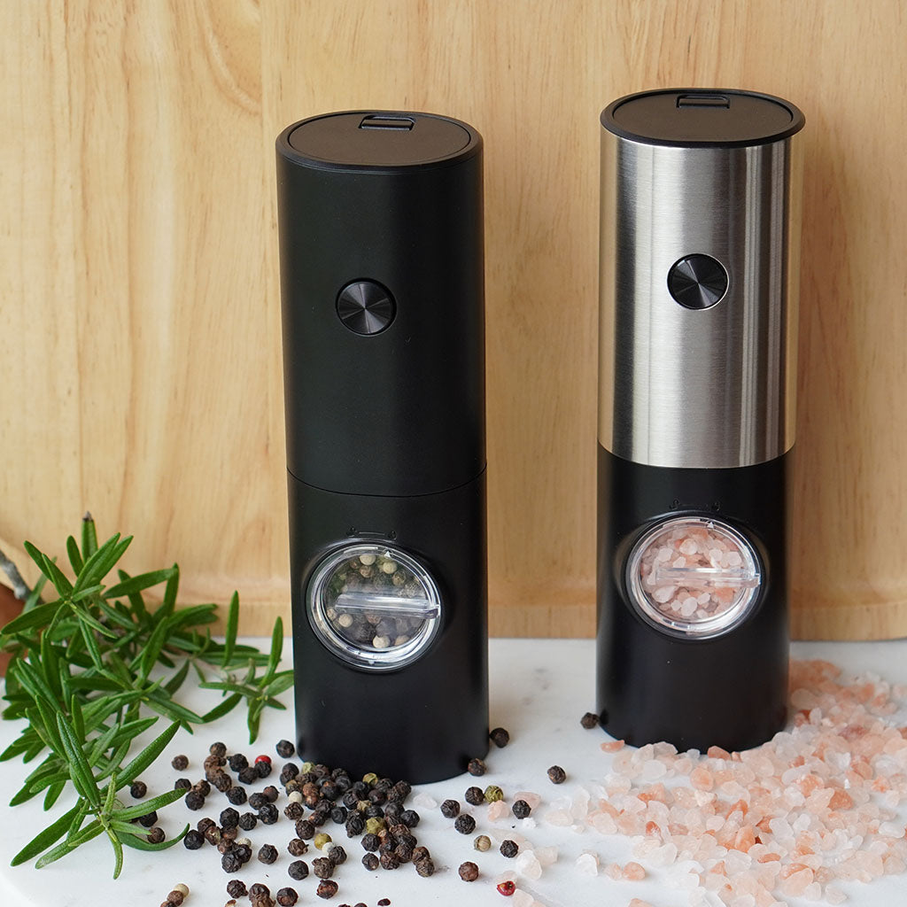 black and stainless steel salt and pepper grinder on marble board