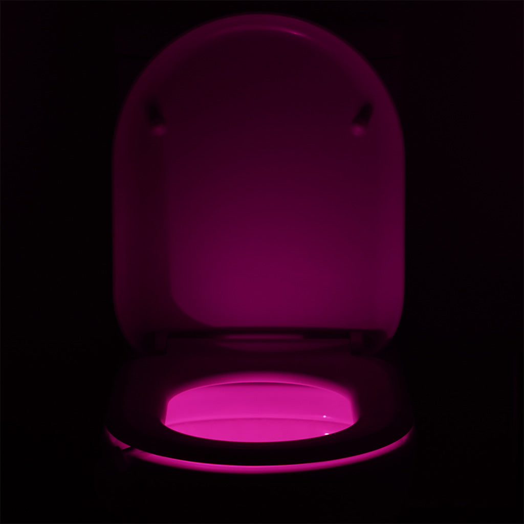 Toilet bowl night light in use at night with purple light